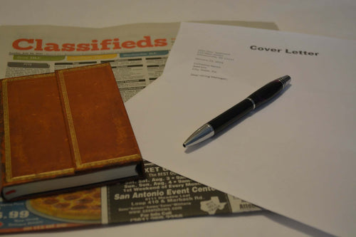 Laid Off Picture or news paper jobs vacant page, with pen and notepaper
