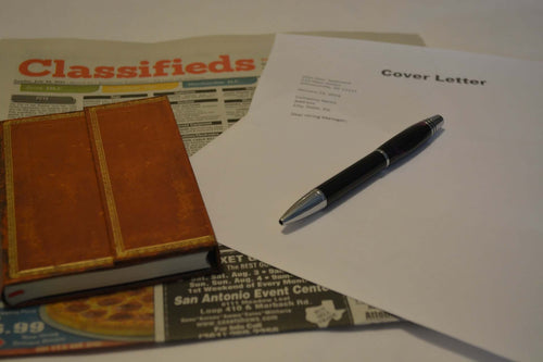 Picture or news paper jobs vacant page, with pen and notepaper