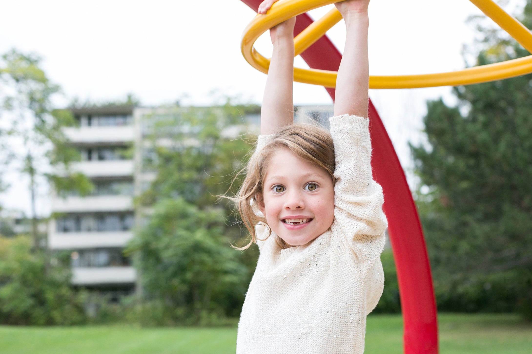 Little girl happily playing on a swing, donating the positive effects of the IBS Audio Program 60 on her IBS Audio Program 60 for Children Functional Abdominal Pain FAP